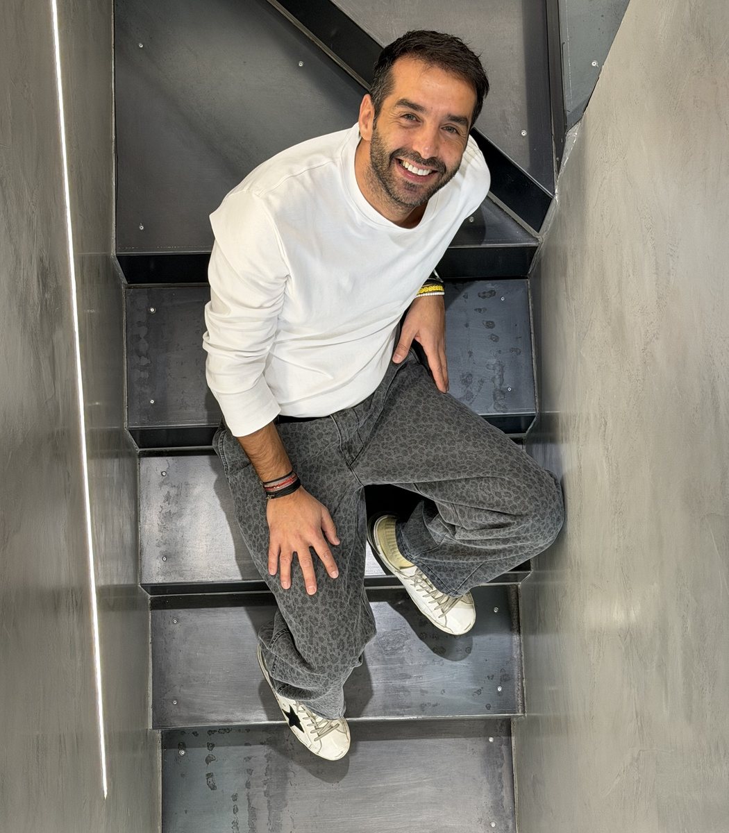 George Tzagkarakis, owner of Inbox Boutique, on the staircase of the store in Nea Smyrni, Athens